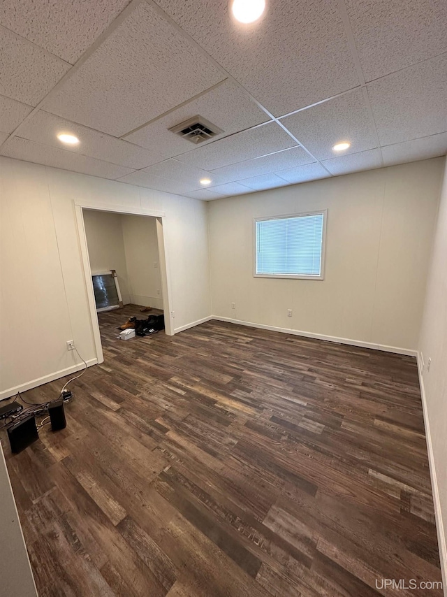 200 Marquette St, Negaunee, MI 49866 - basement featuring wood finished floors, a paneled ceiling, and baseboards