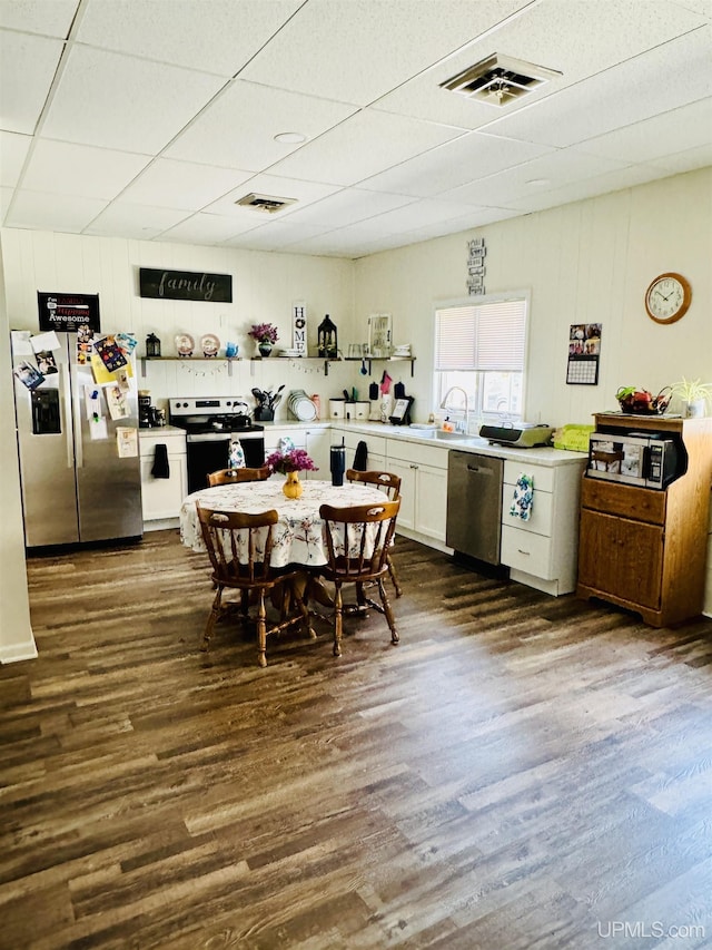 200 Marquette St, Negaunee, MI 49866 - kitchen with appliances with stainless steel finishes, a sink, dark wood finished floors, white cabinetry, and light countertops