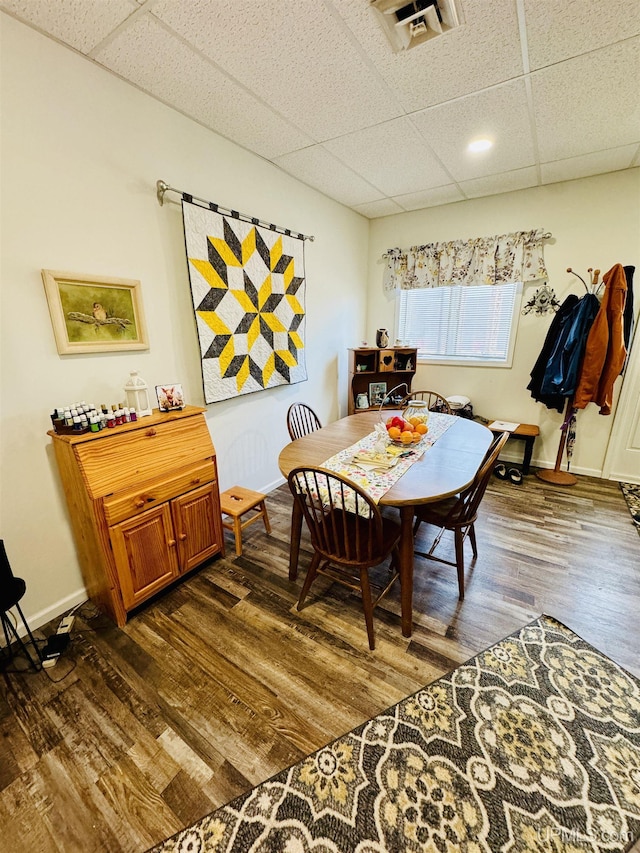 200 Marquette St, Negaunee, MI 49866 - dining area with dark wood-style floors, a drop ceiling, and baseboards