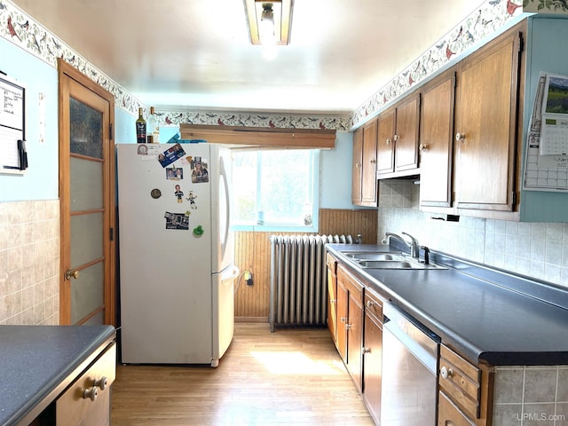 746 Maurice St, Ishpeming, MI 49849 - kitchen with freestanding refrigerator, a sink, radiator heating unit, dishwasher, and light wood finished floors