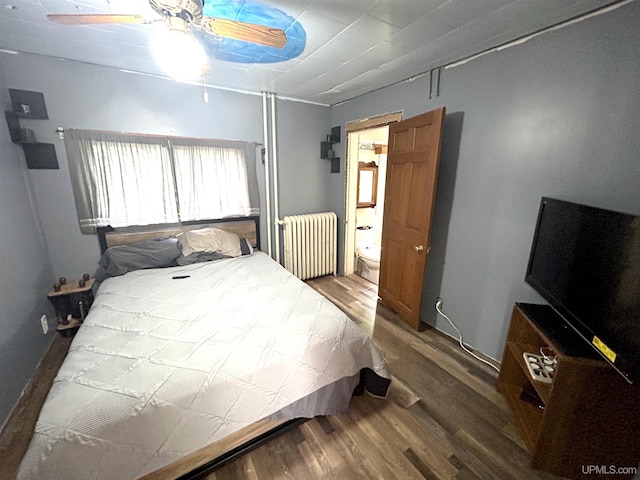 746 Maurice St, Ishpeming, MI 49849 - bedroom with radiator, wood finished floors, ensuite bathroom, and a ceiling fan