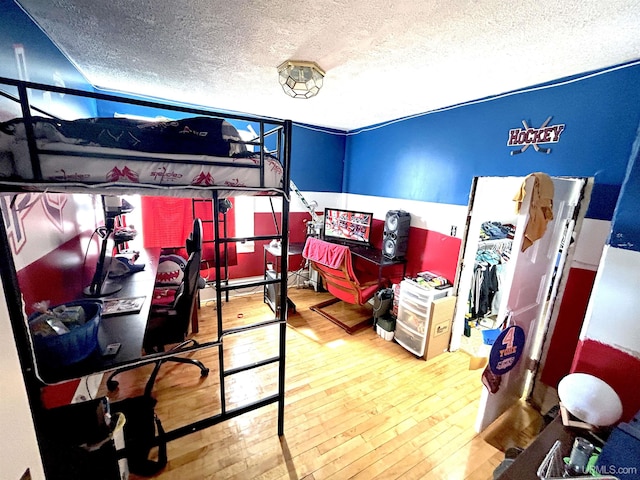 746 Maurice St, Ishpeming, MI 49849 - bedroom with hardwood / wood-style flooring and a textured ceiling