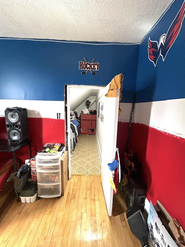 746 Maurice St, Ishpeming, MI 49849 - bedroom featuring wood-type flooring and a textured ceiling