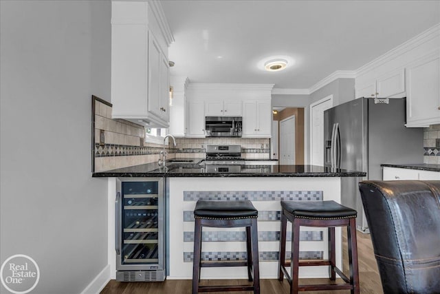 49204 Stratford Dr, Chesterfield Twp, MI 48047 - kitchen with appliances with stainless steel finishes, beverage cooler, a sink, white cabinets, and crown molding