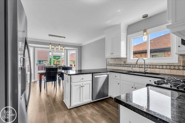 49204 Stratford Dr, Chesterfield Twp, MI 48047 - kitchen with stainless steel appliances, a sink, crown molding, white cabinetry, and a peninsula