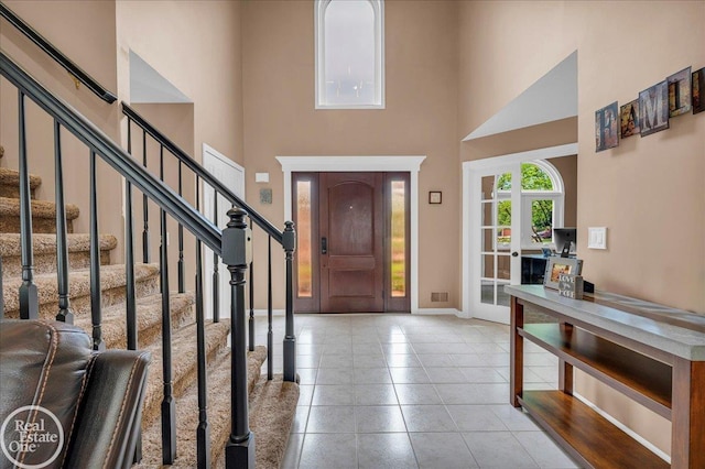 49204 Stratford Dr, Chesterfield Twp, MI 48047 - foyer entrance featuring a towering ceiling, stairway, tile patterned floors, and baseboards