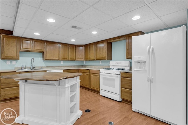 49204 Stratford Dr, Chesterfield Twp, MI 48047 - kitchen featuring white appliances, a sink, light countertops, a drop ceiling, and light wood finished floors