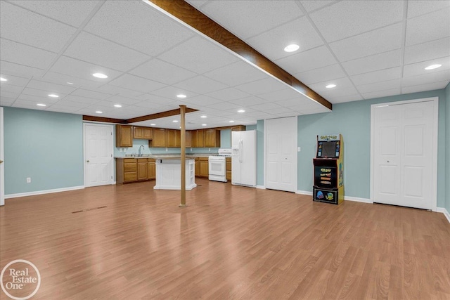 49204 Stratford Dr, Chesterfield Twp, MI 48047 - unfurnished living room featuring baseboards, a drop ceiling, wood finished floors, a sink, and recessed lighting