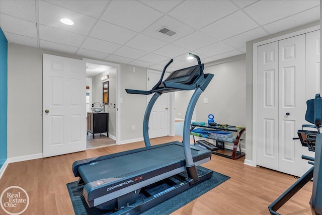 49204 Stratford Dr, Chesterfield Twp, MI 48047 - workout area with wood finished floors, baseboards, and a paneled ceiling