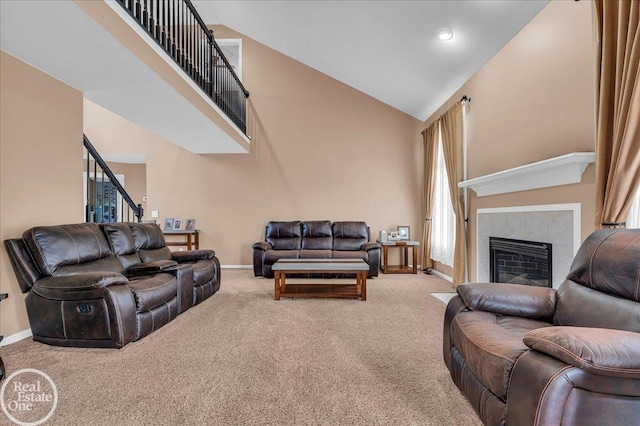 49204 Stratford Dr, Chesterfield Twp, MI 48047 - living room featuring high vaulted ceiling, light carpet, baseboards, a tiled fireplace, and stairs