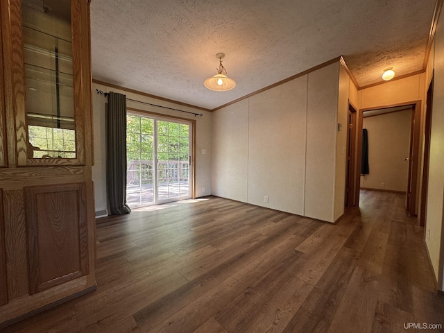 104 Pine St, Greenland, MI 49929 - spare room featuring ornamental molding, dark wood-style flooring, and a textured ceiling