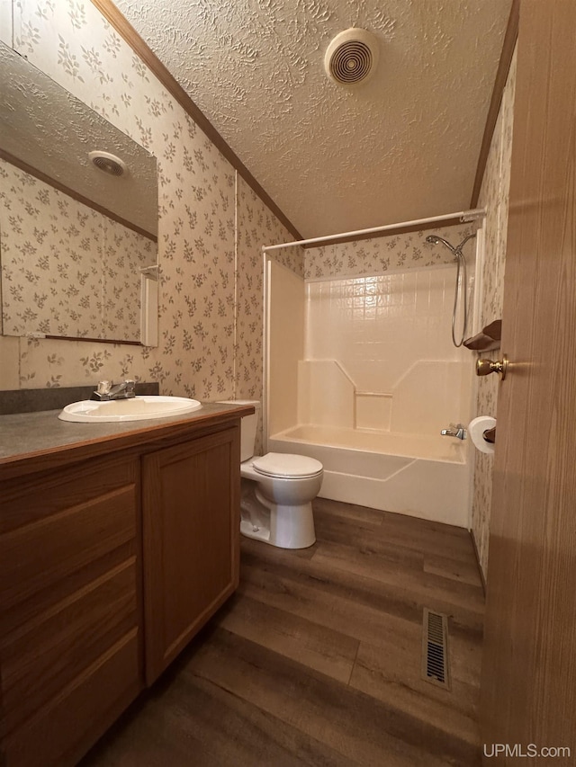 104 Pine St, Greenland, MI 49929 - bathroom with wallpapered walls, wood finished floors, a textured ceiling, tub / shower combination, and vanity