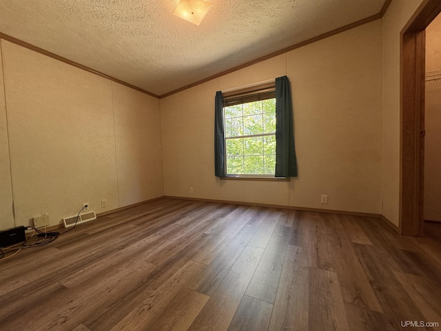 104 Pine St, Greenland, MI 49929 - empty room featuring wood finished floors, a textured ceiling, lofted ceiling, and ornamental molding