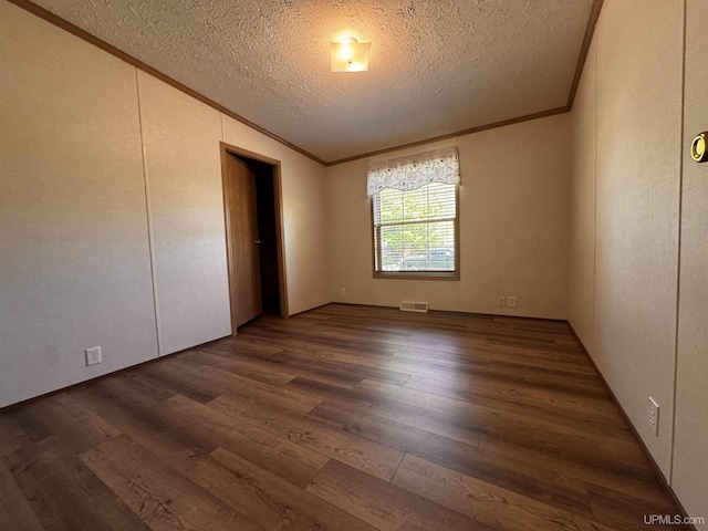 104 Pine St, Greenland, MI 49929 - unfurnished room with ornamental molding, dark wood finished floors, and a textured ceiling