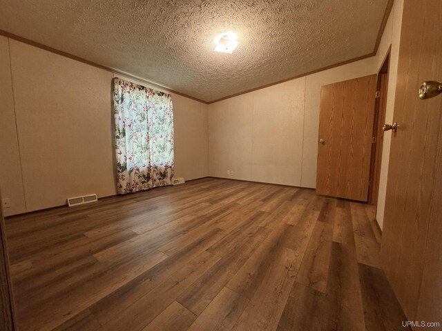 104 Pine St, Greenland, MI 49929 - unfurnished room featuring a textured ceiling, wood finished floors, and ornamental molding