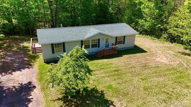 104 Pine St, Greenland, MI 49929 - view of front of home with roof with shingles, a front lawn, and a wooded view