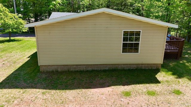 104 Pine St, Greenland, MI 49929 - view of home's exterior featuring a lawn and a wooden deck