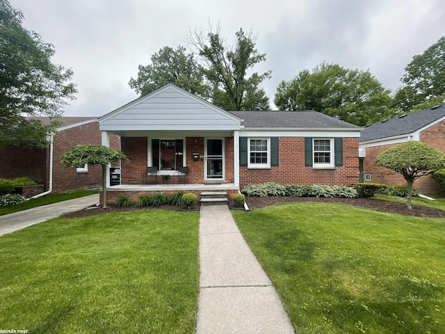 2029 Manchester Rd, Grosse Pointe Woods, MI 48236 - ranch-style house with a porch, brick siding, and a front yard