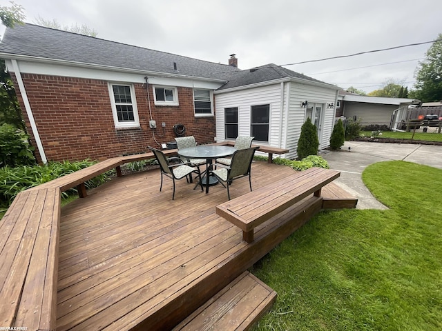 2029 Manchester Rd, Grosse Pointe Woods, MI 48236 - wooden terrace with a lawn and outdoor dining space