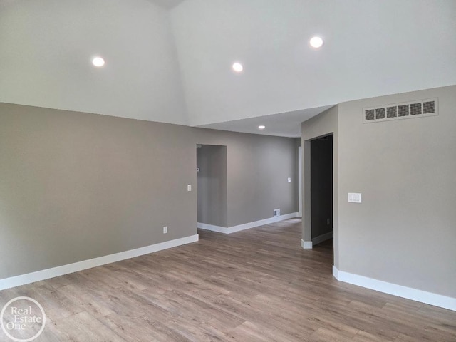 53340 Washington St, New Baltimore, MI 48047 - spare room with baseboards, light wood finished floors, recessed lighting, and high vaulted ceiling