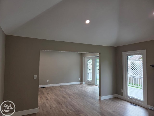 53340 Washington St, New Baltimore, MI 48047 - empty room featuring lofted ceiling, light wood-style floors, and baseboards