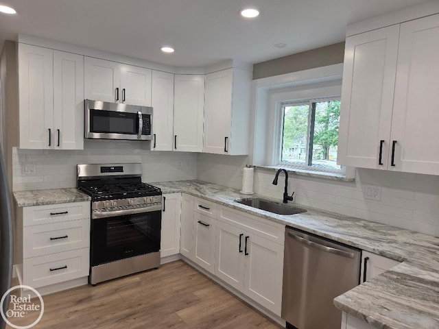 53340 Washington St, New Baltimore, MI 48047 - kitchen featuring appliances with stainless steel finishes, a sink, white cabinets, and recessed lighting