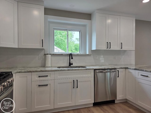 53340 Washington St, New Baltimore, MI 48047 - kitchen featuring stainless steel appliances, a sink, white cabinetry, tasteful backsplash, and recessed lighting