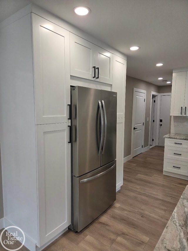 53340 Washington St, New Baltimore, MI 48047 - kitchen with freestanding refrigerator, white cabinetry, light wood finished floors, recessed lighting, and light stone countertops