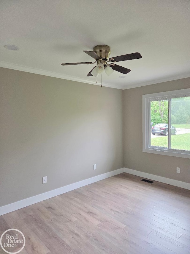 53340 Washington St, New Baltimore, MI 48047 - spare room with crown molding, light wood-style floors, a ceiling fan, and baseboards