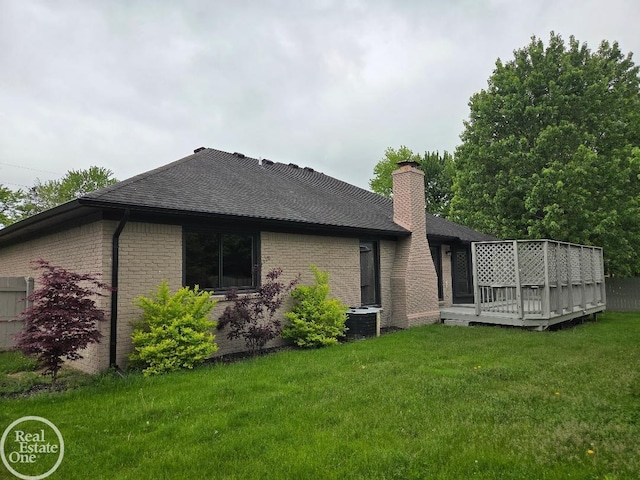 53340 Washington St, New Baltimore, MI 48047 - rear view of property with a shingled roof, a lawn, a wooden deck, brick siding, and central AC unit