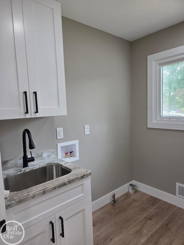53340 Washington St, New Baltimore, MI 48047 - laundry room featuring washer hookup, wood finished floors, baseboards, gas dryer hookup, and cabinet space