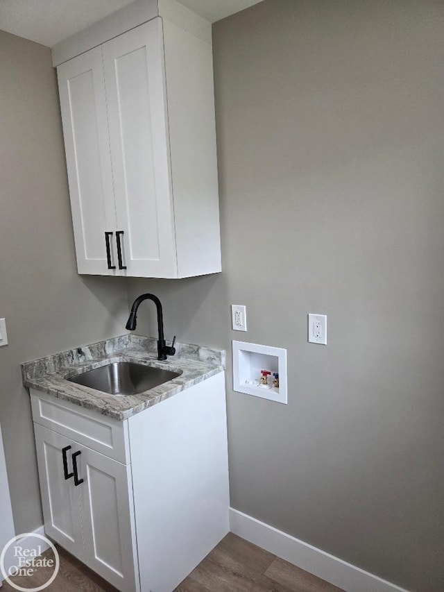 53340 Washington St, New Baltimore, MI 48047 - laundry room featuring hookup for a washing machine, baseboards, dark wood finished floors, and cabinet space