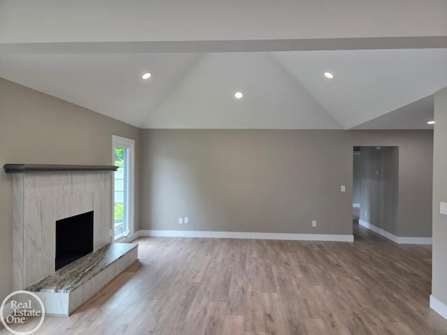 53340 Washington St, New Baltimore, MI 48047 - unfurnished living room featuring lofted ceiling, baseboards, light wood-style floors, a fireplace, and recessed lighting