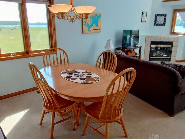 1750 Castleview Ct, Gladwin, MI 48624 - dining space featuring a chandelier, a tile fireplace, and light carpet