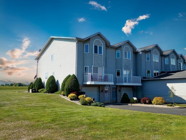 1750 Castleview Ct, Gladwin, MI 48624 - view of front of house with a front lawn, a garage, driveway, and a balcony