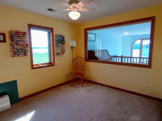 1750 Castleview Ct, Gladwin, MI 48624 - sitting room with healthy amount of natural light, carpet, a ceiling fan, and baseboards
