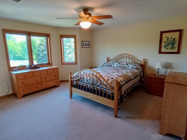 1750 Castleview Ct, Gladwin, MI 48624 - bedroom featuring light colored carpet, a ceiling fan, and baseboards