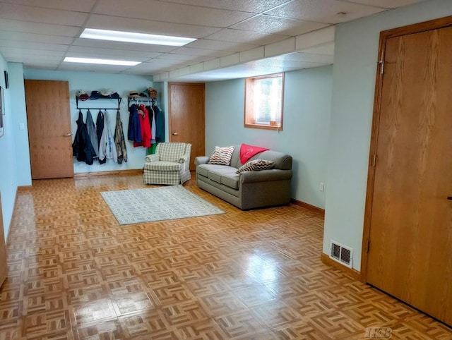 1750 Castleview Ct, Gladwin, MI 48624 - living area featuring a paneled ceiling and baseboards