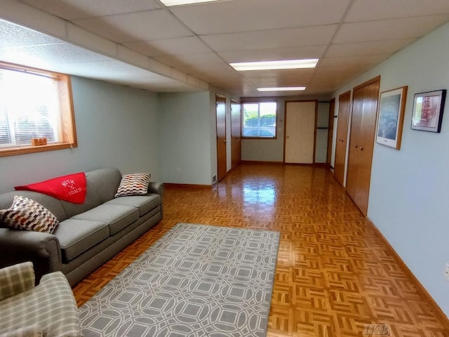 1750 Castleview Ct, Gladwin, MI 48624 - living area with a paneled ceiling and baseboards