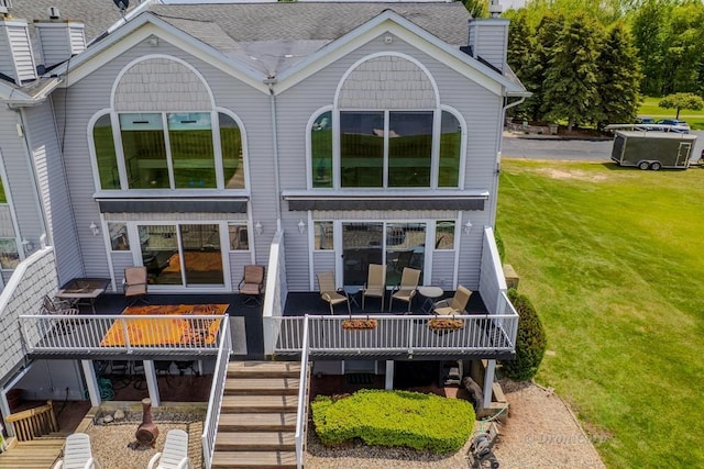 1750 Castleview Ct, Gladwin, MI 48624 - rear view of house with a chimney, a wooden deck, a yard, and stairs