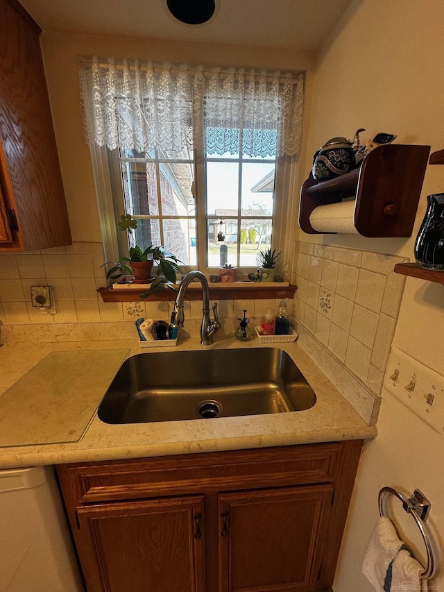 5408 Holy Cross Ct, Warren, MI 48091 - kitchen featuring a sink, decorative backsplash, and light countertops