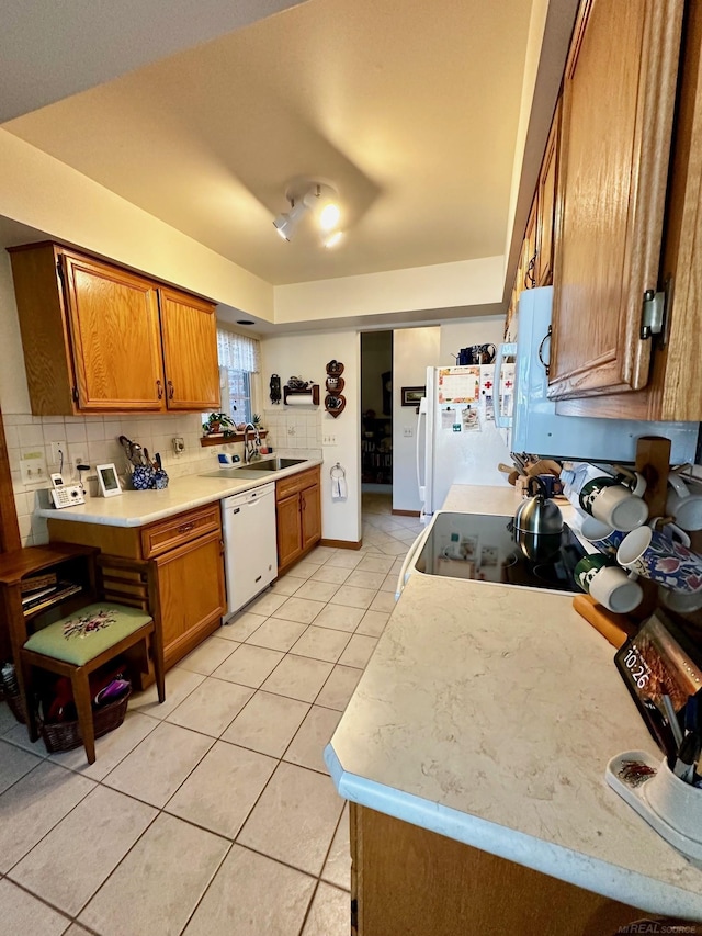 5408 Holy Cross Ct, Warren, MI 48091 - kitchen with white appliances, brown cabinets, light tile patterned flooring, light countertops, and a sink