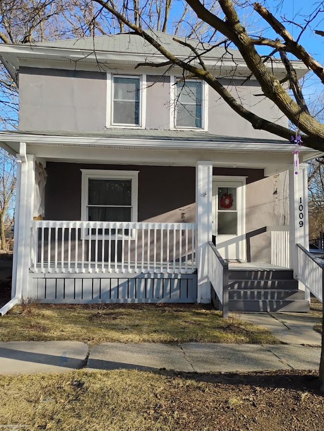 1009 May St, Lansing, MI 48906 - view of front facade with a porch and stucco siding