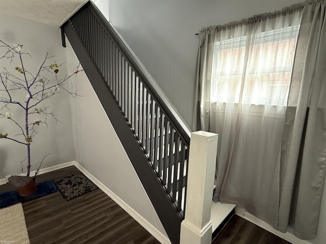 1009 May St, Lansing, MI 48906 - stairs featuring wood finished floors and baseboards