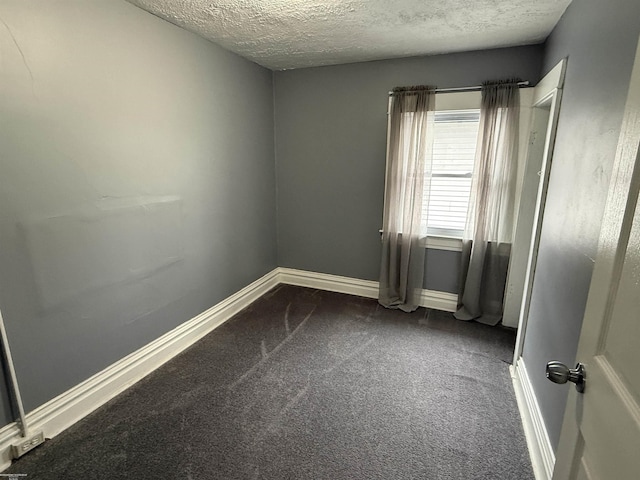 1009 May St, Lansing, MI 48906 - empty room with a textured ceiling, dark carpet, and baseboards