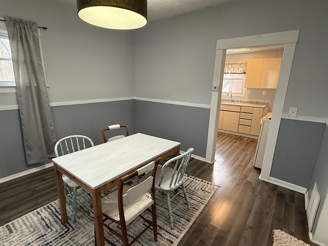 1009 May St, Lansing, MI 48906 - dining area featuring dark wood finished floors, wainscoting, and baseboards