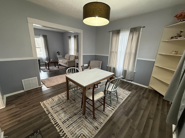 1009 May St, Lansing, MI 48906 - dining room with dark wood-type flooring and wainscoting