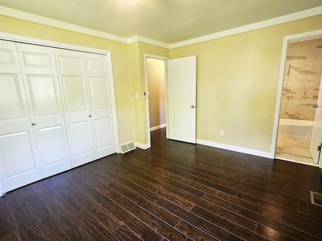 3045 W Birch Dr, Bay City, MI 48706 - unfurnished bedroom with dark wood-style floors, baseboards, a closet, ensuite bathroom, and ornamental molding