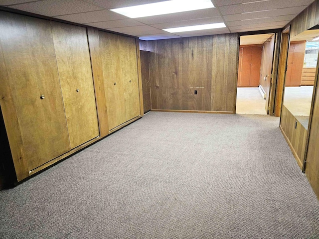 3045 W Birch Dr, Bay City, MI 48706 - finished basement with light colored carpet, a drop ceiling, and wooden walls