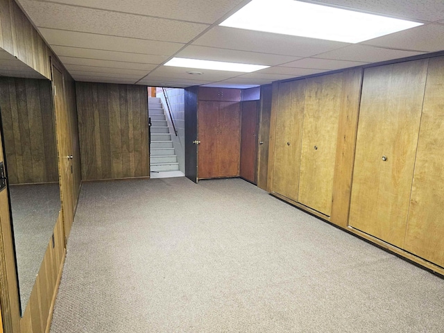 3045 W Birch Dr, Bay City, MI 48706 - finished basement featuring stairway, wood walls, a paneled ceiling, and light carpet